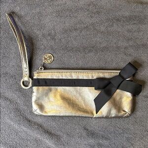 LINDSAY PHILLIPS wristlet champagne with black bow